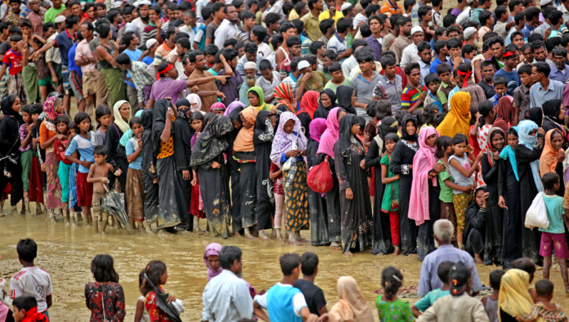 COX'S BAZAR, BANGLADESH - SEPTEMBER 20, 2017: Rohingya Muslim people, who crossed over from Myanmar into Bangladesh, wait for their turn to collect food aid near Kutupalong refugee camp, Bangladesh.