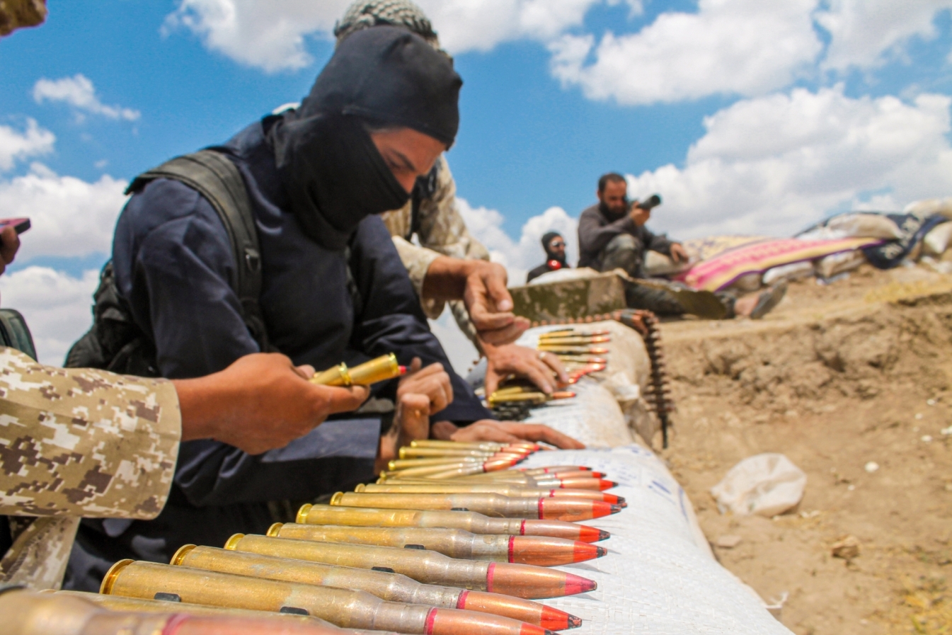 Men preparing ammunition