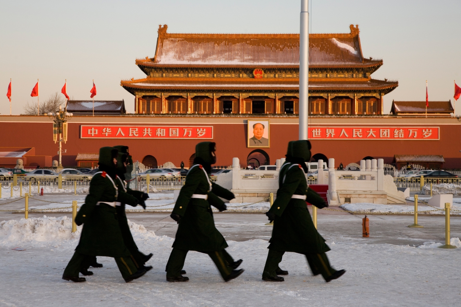 A group of security stuff patrol in Tian'anmen Square after the dawn flag raising ceremony January 16, 2010 in Beijing, China.