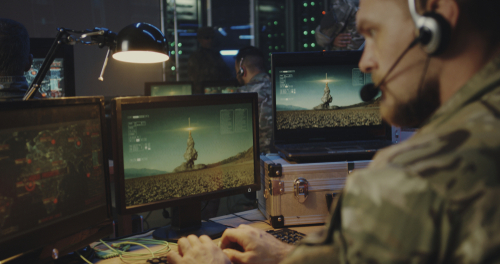 Medium close-up of soldiers controlling rocket launch on computer