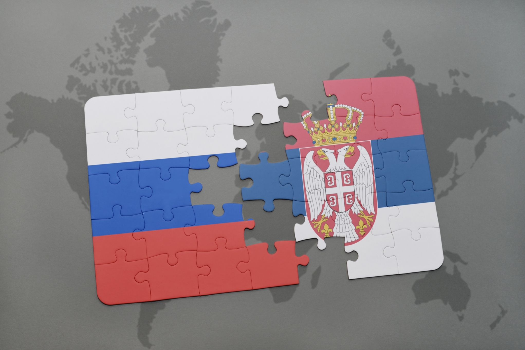 puzzle with the national flag of russia and serbia on a world map background. 3D illustration