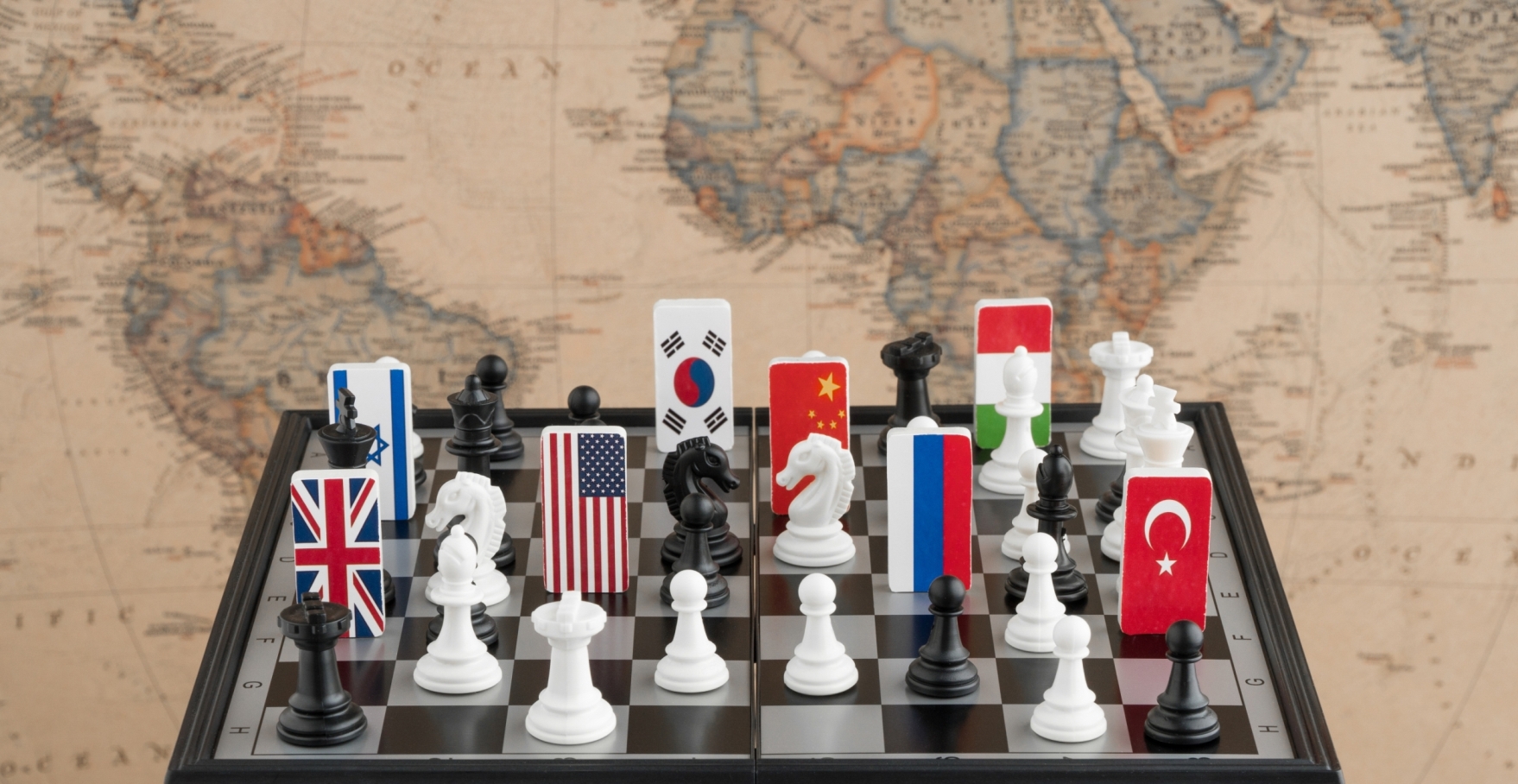 Flags and Chess Figures on a Chess Board; Map in the Background