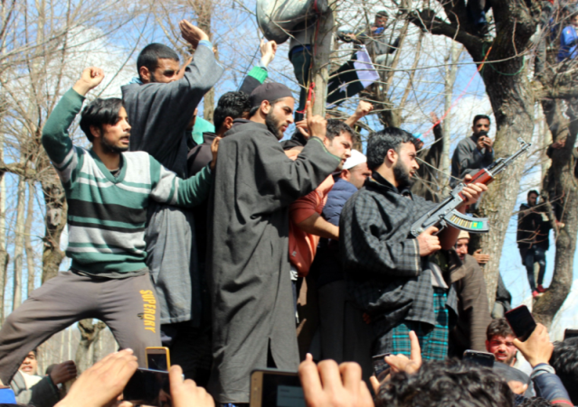 Kashmiri armed rebels giving gun-salute to their comrade during funeral processions of rebel Aashiq Hussain Bhat at Rakhpora area of south Kashmirs Shopain district on March, 05, 2018.